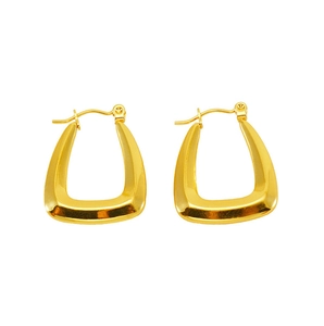 Detailed view of polished gold U-shaped thick earrings with a sleek minimalist design
