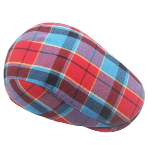 Detail of colorful plaid flat cap with red blue and yellow tartan wool fabric