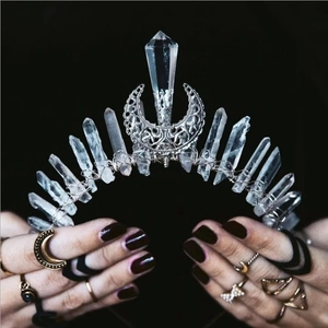 Handmade crown with clear crystal points and crescent moon detail on a dark background