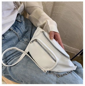Detail of white textured PU waist bag with silver zippers and stylish chain strap