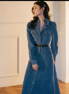 Blue corduroy dress detail with lapel collar, flap pockets and black belt