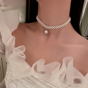 Elegant double-layered pearl choker necklace with a large pearl pendant on model