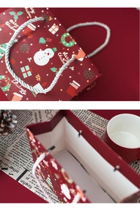 Detail of red Christmas paper gift bag with snowman print and white woven handle