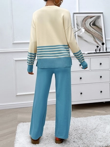 Rear view of knit two-piece set featuring beige long-sleeve top and blue wide-leg trousers