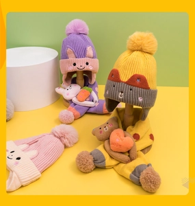 Detailed view of colorful knit hats and scarves set with cute 3D bunny and bear ears