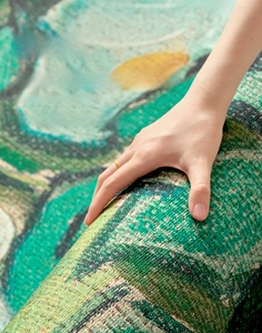 Macro detail of the green and beige abstract rug showing high-density woven texture