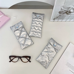 Three quilted silver PU sunglasses pouches with heart snaps and soft padded texture