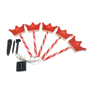 Solar powered red crown LED lawn lights with festive striped stakes and solar panel