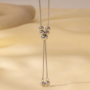Detailed view of silver titanium steel snake chain with polished round bead pendants