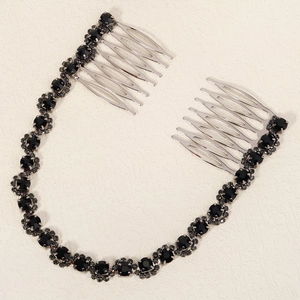 Detailed view of silver bridal hair comb set with sparkling black crystals and chain links