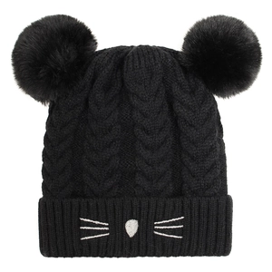 Detailed knit texture of a black baby beanie featuring cute embroidered cat whiskers and ears
