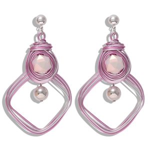 Bohemian handmade wire wrapped heart earrings with pink beads and silver wire on white background