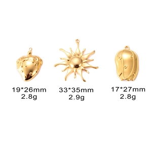 Detailed view of 18k gold-plated strawberry, sun and tulip charms with size measurements