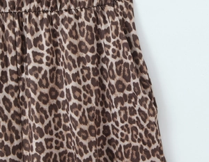 Detail of vintage leopard print jumpsuit showing elastic waist and side pocket texture