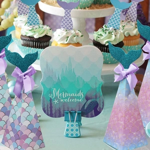Detailed view of mermaid party decoration set with teal scales and satin bow accents