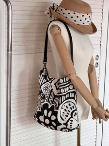 Detail of bohemian linen tote bag featuring black and white abstract geometric prints