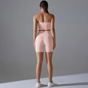 Pink two-piece yoga set with strapless tube top and high-waist lifting biker shorts