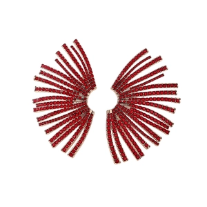 Boucles d'oreilles dorées en éventail avec strass rouges radiants sur fond blanc