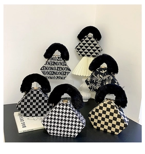 Detail of diverse hexagonal handbags with faux fur handles and geometric patterns