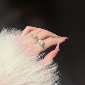Macro detail of gold and silver plated watch-style rings with pavé zircon settings