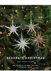 Detailed view of white and champagne gold glitter star ornaments on a Christmas tree