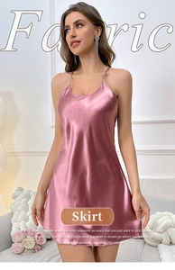Detail of pink silk satin nightdress featuring delicate straps and V-neckline fabric texture