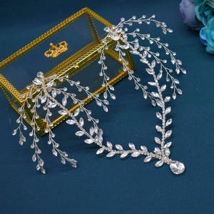 Detail of silver bridal headband with sparkling crystals and a teardrop rhinestone pendant