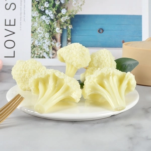 Realistic artificial broccoli models in a white ceramic plate for kitchen decoration