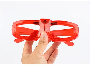 Detail of red glow glasses showing battery compartment and power switch mechanism