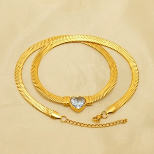 Golden heart zircon pendant necklace and bracelet set with sleek snake chain on silk