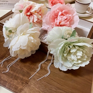 Elegant floral claw clips with long rhinestone tassels and soft silk flower petals for women