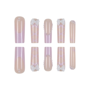 Long square press-on nails with purple French tips, ballet-style bows, and pearls