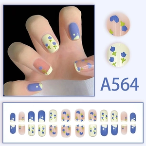 Detail view of A564 press-on nails featuring blue tulips, dots and mixed color designs