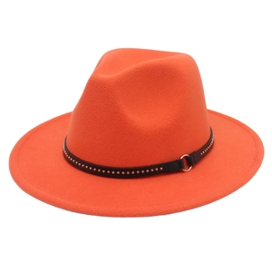Detail of orange wool felt fedora featuring black leather strap with metal studs and ring