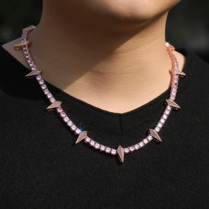 Macro view of rose gold tennis chain with pink zircon stones and spiked charms