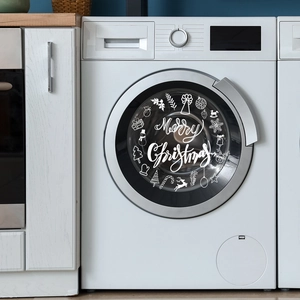 Close-up of Merry Christmas vinyl decals with snowflake and reindeer on washing machine