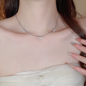 Close-up of elegant silver stainless steel necklace with sparkling zircon drop pendants