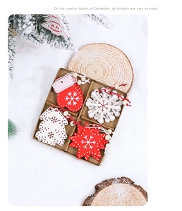 Detail of red and white wooden Christmas ornaments with snowflake and star shapes in box