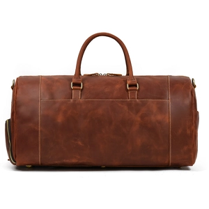 Macro view of brown crazy horse leather texture and stitching on travel duffel bag