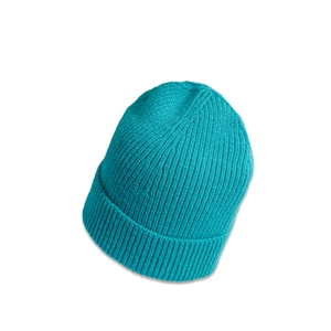 Close-up detail of the ribbed knit texture on a turquoise winter beanie hat
