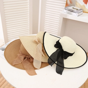 Three wide brim straw hats with elegant bows in khaki, cream and white for sun protection