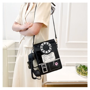 Detail of creative vintage dial phone crossbody bag with glossy finish and receiver