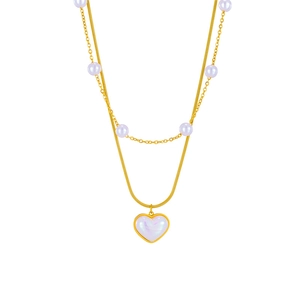 Detail of double-layer gold necklace featuring white pearls and a marble heart pendant