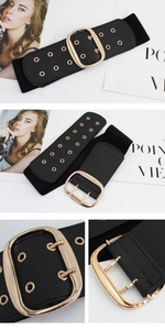 Detail of a wide elastic waist belt with a golden rectangular buckle and metal eyelets