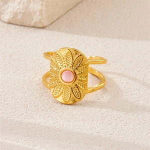 Macro shot of 18k gold plated open ring with pink opal gemstone and retro sunburst details