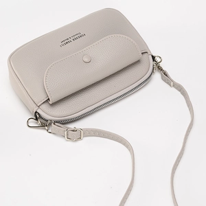 Grey pebbled leather crossbody phone bag with front pocket and adjustable strap