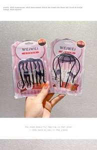 Macro detail of black U-shaped hair combs for bun styling in minimalist packaging