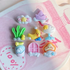 Close-up of pastel resin charms including clouds, stars, and ducks for DIY crafts