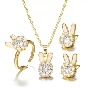 Detail of gold rabbit jewelry set with white ears and sparkling zircon crystals