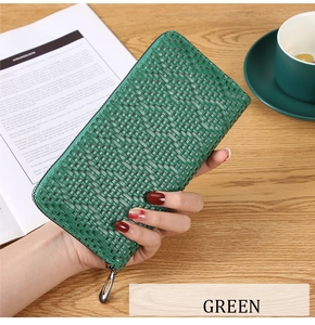 Detailed view of long green women's wallet with woven texture and zipper closure